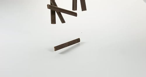 Chocolate Sticks Falling on White Background