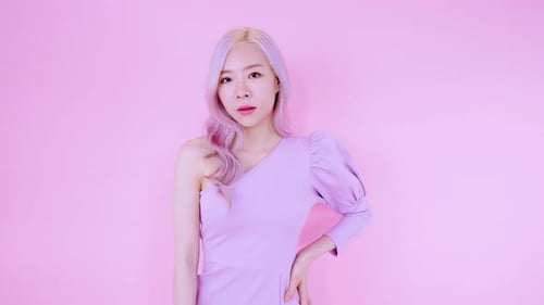 Asian young woman standing and posing with pink background