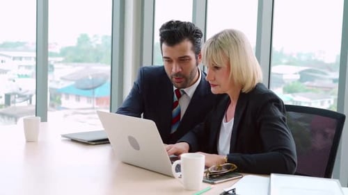 Two Happy Business People Celebrate at Office