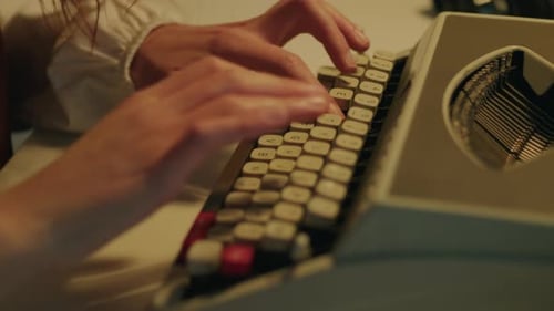 Close Up of Young Girl Writes on Typewriter