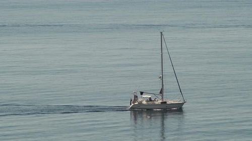 Sailboat Cruises across Calm Blue Water