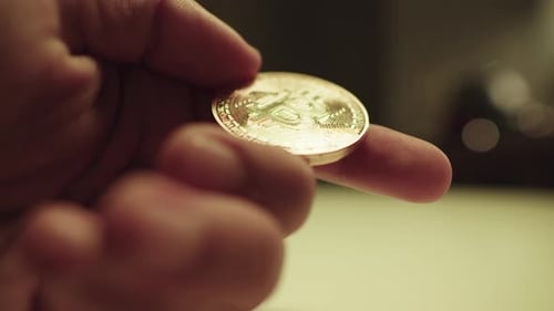 Hand Holding Gold Bitcoin Currency Coin