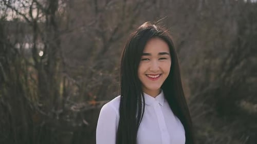 Beautiful Thai Girl Is Looking at Camera and Smiling Cutely. Teen Happy and Kind