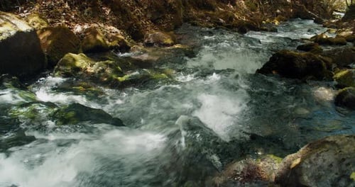 Water is Flowing From Mountain on Rocks Natural Scenery with River