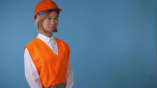 Smiling Young Adult Construction Worker Gives Thumbs Up