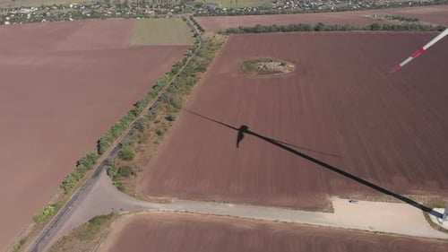 Silhouette of windmill with large blades in field, Alternative energy, Energy production