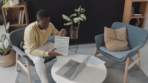 Musician Studies Music with Laptop
