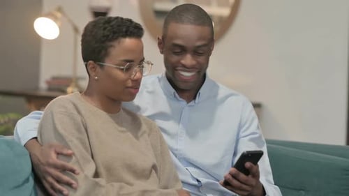 Man and Woman Looking at Phone Together