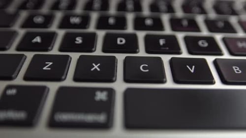 Close-up macro view of keyboard on the laptop computer. 4k footage of modern laptop keyboard