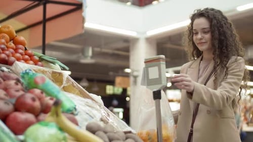 Customer Weighing Vegetables on Scales
