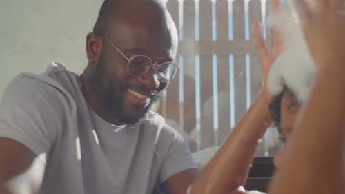 Father Washes Child with Soapsuds in Bathtub