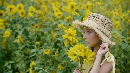 Portrait Beautiful Girl in Straw Hat Holding Yellow Sunflowers on Flowering Field. Smiling Country