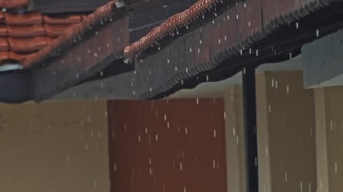 Rain Falling from House Roof during Storm