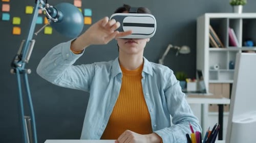 Slow Motion of Young Woman Wearing Virtual Reality Glasses Moving Arms in Office
