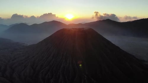 Aerial view of sunrise over mountains and clouds