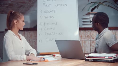 Teacher Instructing Student in English Lesson