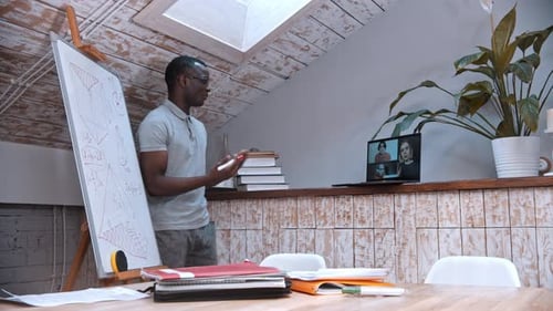 Teacher giving online class using laptop and whiteboard