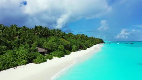 Luxury above copy space shot of a white sandy paradise beach and blue ocean background in 4K