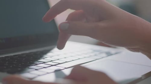 Hands Typing on Laptop Computer Keyboard Close Up