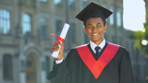 Joyful College Student Showing Diploma Celebrating Graduation Day, Achievement