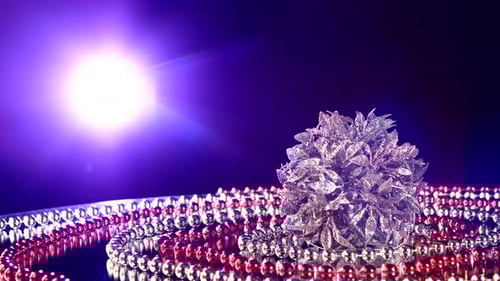 Sparkling Christmas Ornament Surrounded by Red and Silver Beads