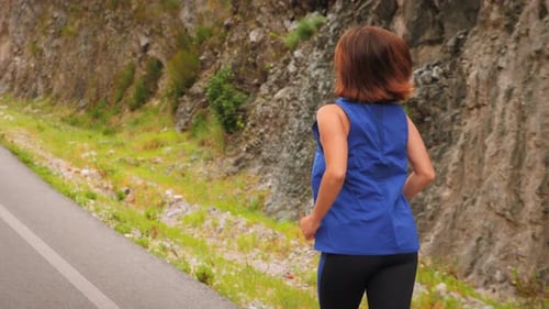 Back follow shot of running woman