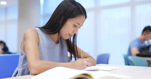 Young Woman study at university library