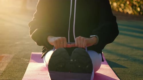 Woman Exercises Outdoors With Resistance Band