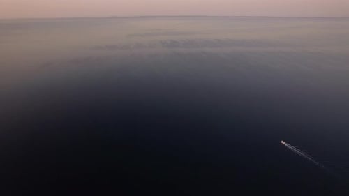 Vast water surface with sailing motor boat