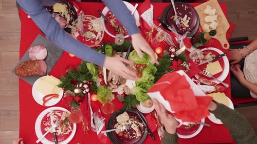 Top View of Girl Giving Gift Box Over the Christmas Table