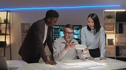 Car Designers Celebrating Successful Collaboration in a Modern Office