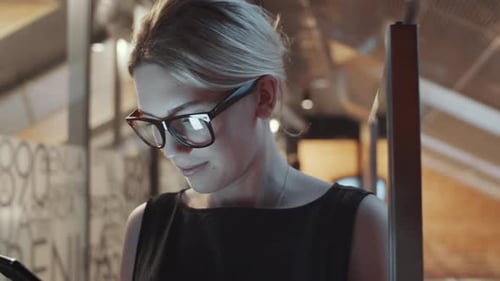 Woman Using Cell Phone in Modern Workplace