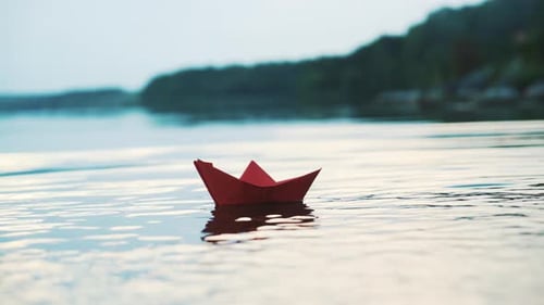 Red Paper Boat Floating Calmly on Gentle Water