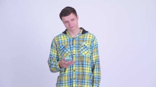 Man in Plaid Shirt Uses Cellphone