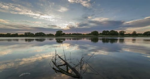 Timelapse of Beautiful Cloudy Sunrise in a Lake with Reflection