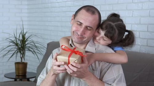 Girl Giving Present to Happy Smiling Father
