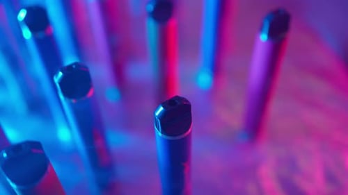 Disposable Vapes Under Bright Neon Lighting