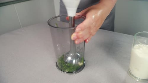 Blending Herbs in Kitchen with Immersion Blender