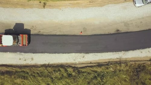 Aerial View of New Road Construction with Steam Roller Machine at Work