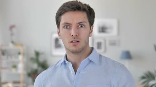 Man Expressing Shock and Covering Mouth