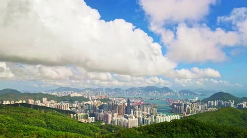 Lufthyperlapse von Kowloon, Hongkong. Vom Berg nach Hongkong.Blauer Himmel bewegende Wolken