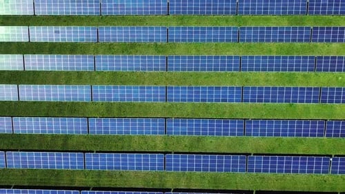 Rows of Photovoltaic Solar Panels on Field. Aerial Landscape with Solar Cells.