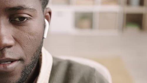 Adult With Earbud Talking Close Up