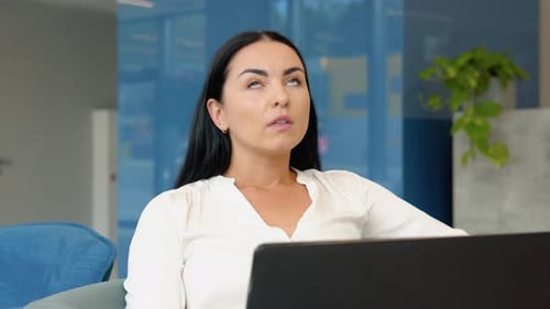 Woman Stretching During Computer Work Day