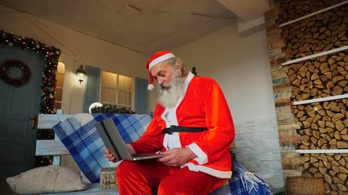 Santa Claus Video Calling on Laptop at Home