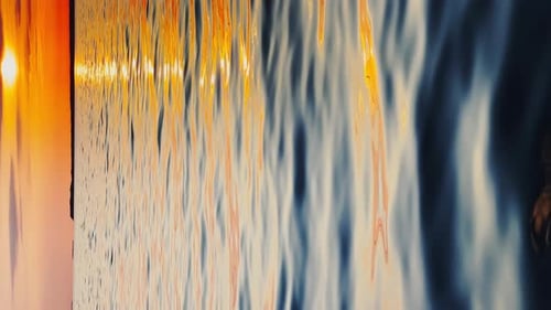 Still Water of Sea at Sunset the Clear Sky Small Waves Magic Sun Reflections Sky of Orange Color