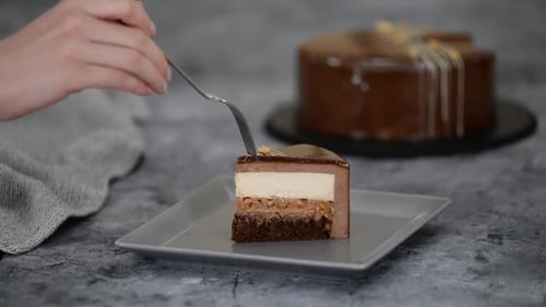 Elegant Slice of Layered Chocolate Cake Being Cut