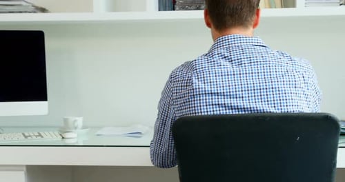 Man Working at Home Answering Phone Call