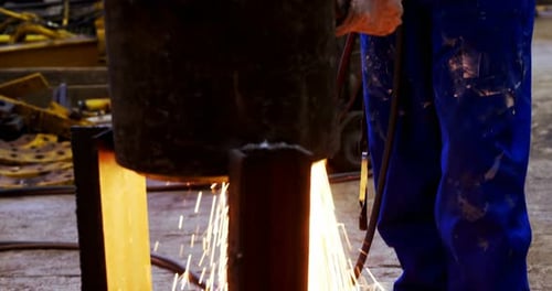 Welder Creates Sparks in Industrial Workplace