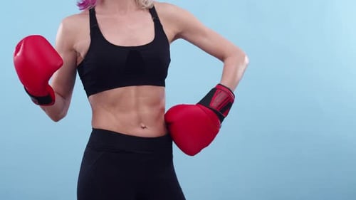 Athletic Woman in Boxing Gloves Poses